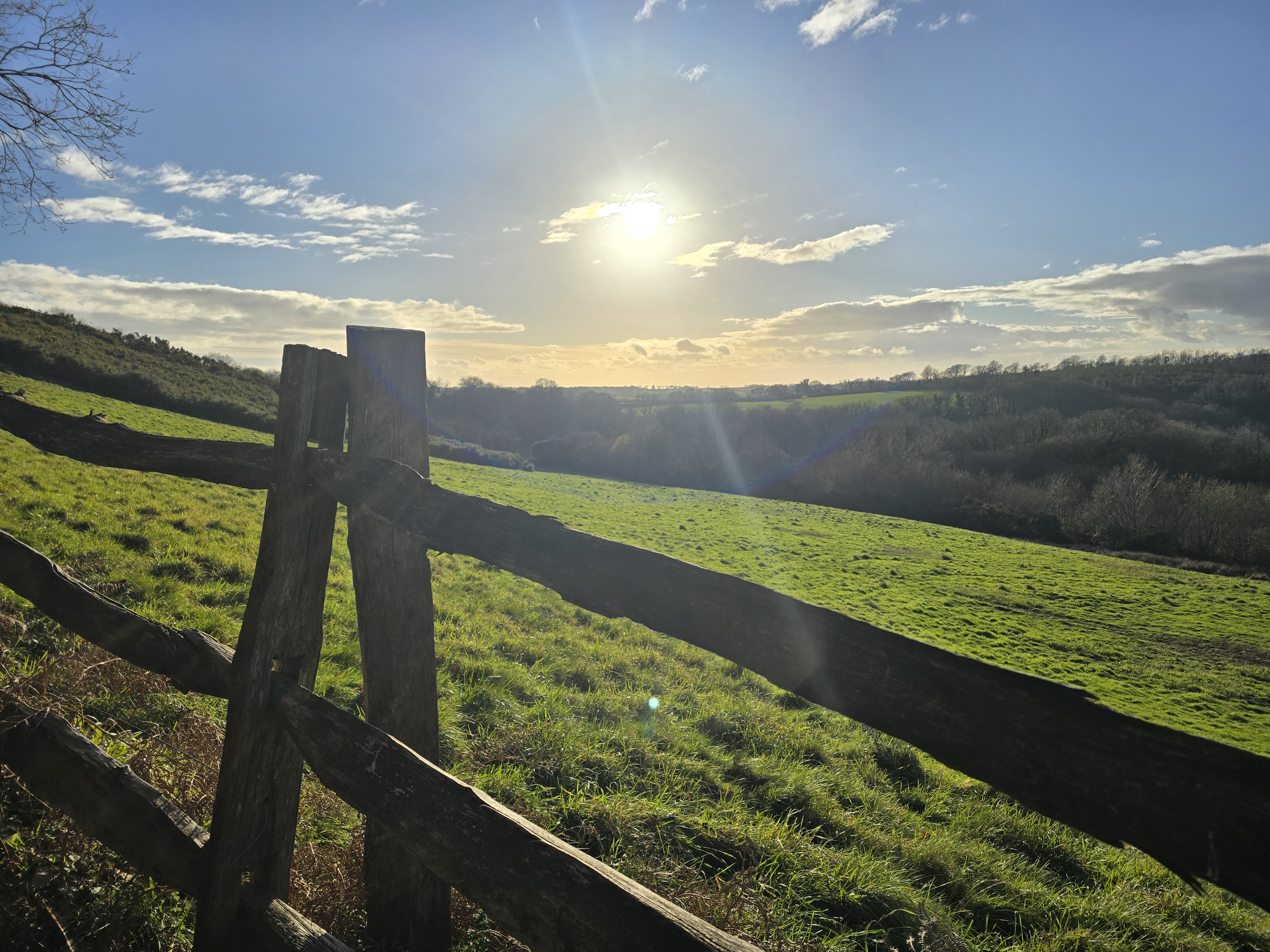 Fence post and valley at low sun, Dorset — the view at the end of a good run